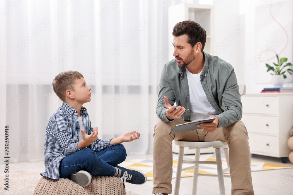 Fototapeta premium Dyslexia treatment. Therapist working with boy in room