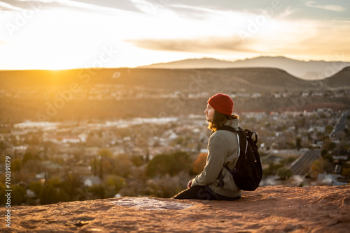 Portrait Person With Bright Red Beanie in St George, Utah Dixie Rock wearing Backpack Outside Sunset Golden Hour Red Rocks