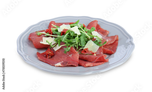 Plate of tasty bresaola salad with sun-dried tomatoes and parmesan cheese isolated on white