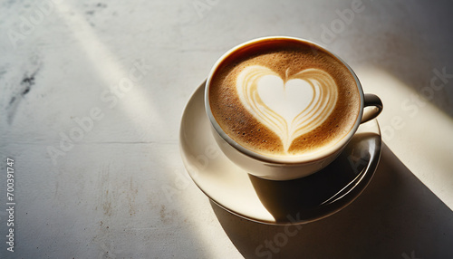 steaming cup of cappuccino adorned with a heart-shaped foam design on a saucer, symbolizing warmth and love photo