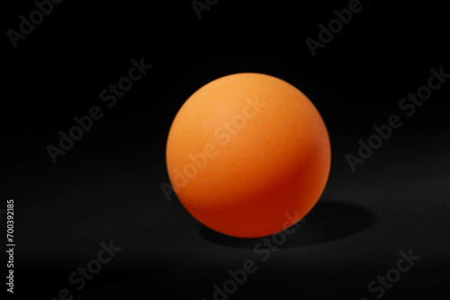 One ping pong ball on black background