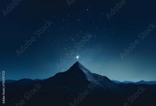 A star in the sky above a mountaintop