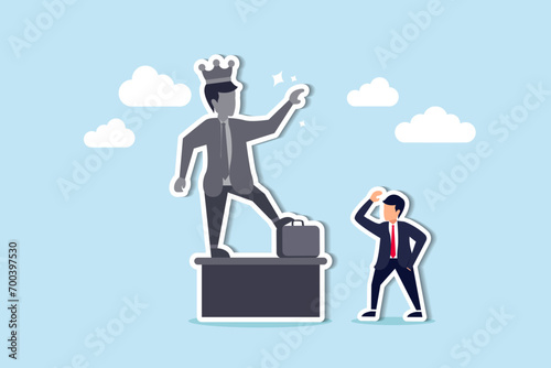 Ego, self important or self esteem, too much proud of yourself or overconfident, success or leadership history concept, businessman looking at his self success statue thinking of own Ego. photo