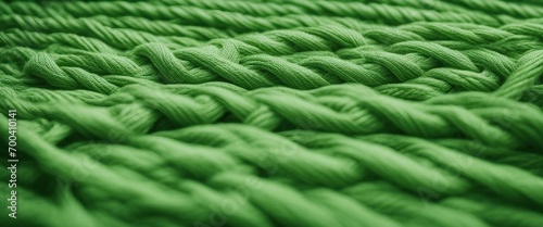 The fabric is knitted green with a large yarn. Large knitting needles.