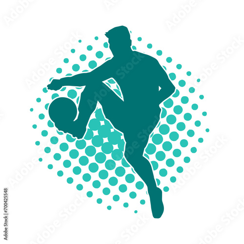 Silhouette of a male soccer player kicking a ball. Silhouette of a football player in action pose.