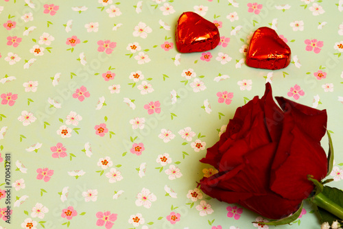 valentines day chocolates and rose on a flower patterned background