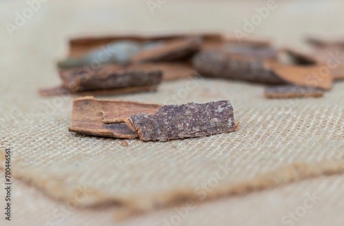 Closeup of Cinnamon Bark Spices in Isolated on Burlap Fabric in Horizontal Orienation photo