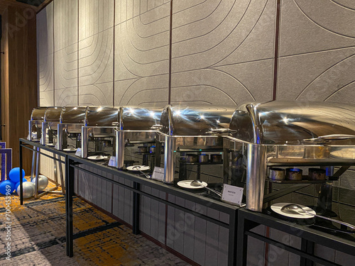 Several roll top chafing dish on buffet table on hotel or restaurant. Closed chafing dish