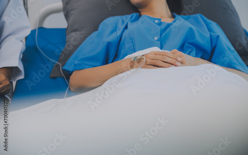 Asian Doctor make routine health check with patient in hospital ward