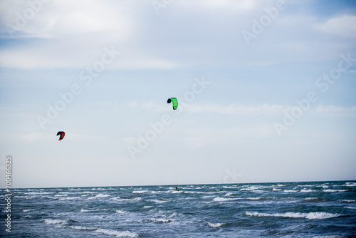 Sportsman kitesurfing on sea waves