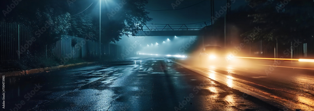 car with headlights on on a rainy city street on midnight - obrazy, fototapety, plakaty 