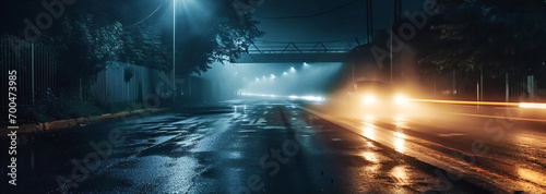 car with headlights on on a rainy city street on midnight