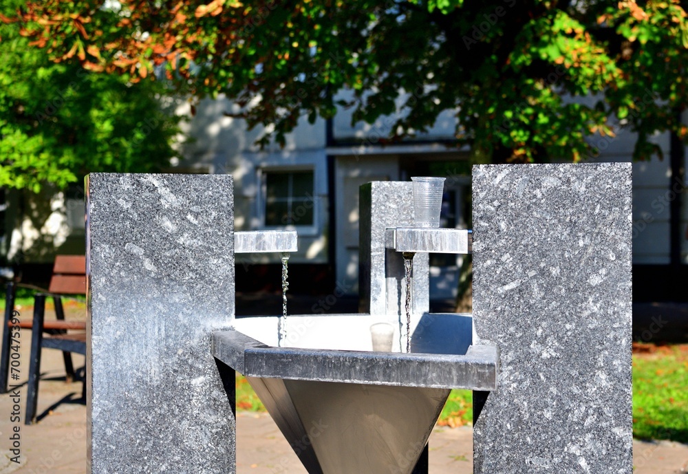 Stone drinking water well on the square for spa guests