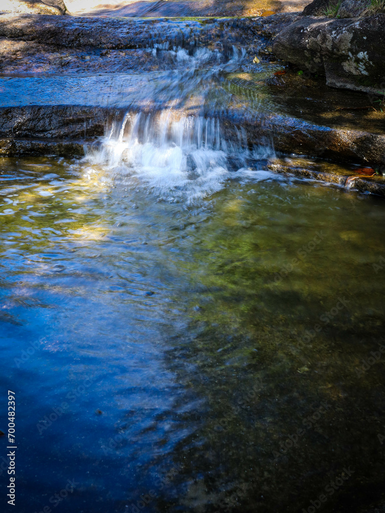 Fototapeta premium water flowing over rocks