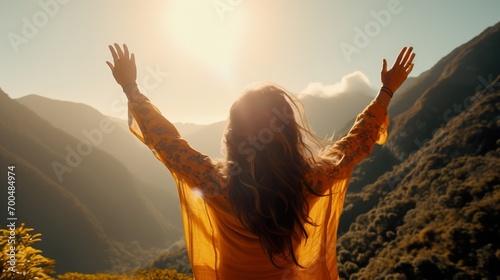 The back of a female relaxing outdoor morning with mountains People freedom concept  inspiration facing the sun