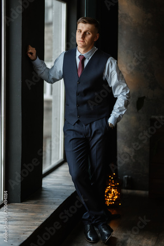 portrait of a cheerful groom in a blue suit