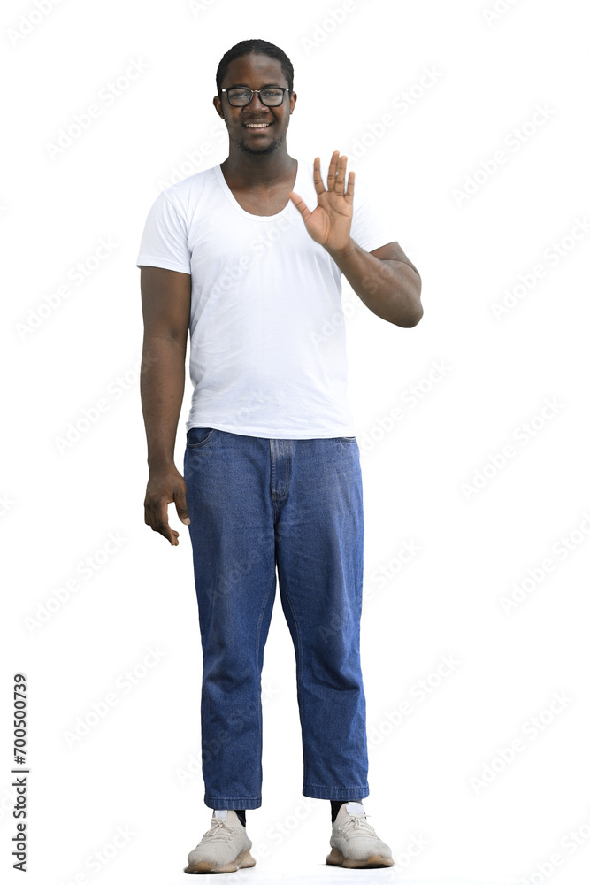 Fototapeta premium A full-length man in a white T-shirt on a White background waves his hand