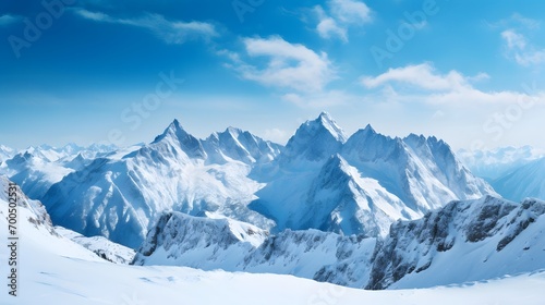 Panoramic view of mountains in winter with snow and blue sky