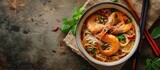 Bowl of curry laksa a spicy glass noodle dish popular in Southeast Asia with prawns bok choy lime ginger and chili Most variations of laksa are prepared with a rich and spicy coconut soup