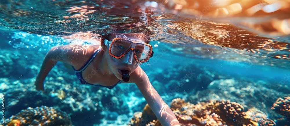 Child snorkeling Kids swim underwater Beach and sea summer vacation with children Little girl watching coral reef fish Marine life on exotic island Kid swimming and diving with snorkel and mask