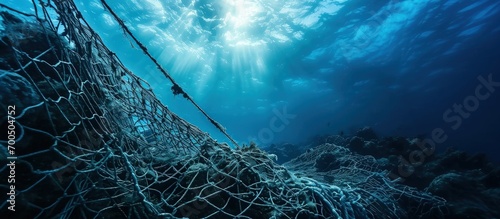 A fishing net underwater fixed on the seabed deep water. Creative Banner. Copyspace image