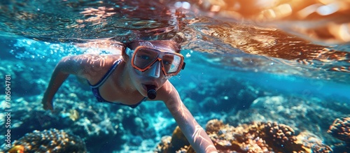 Child snorkeling Kids swim underwater Beach and sea summer vacation with children Little girl watching coral reef fish Marine life on exotic island Kid swimming and diving with snorkel and mask photo