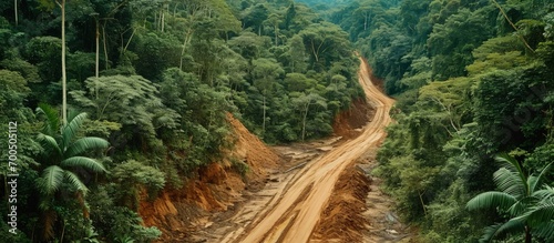 Aerial view of Amazon Rainforest deforestation illegal gold mine and PC tractor mercury contaminated river water from mining forest trees and dirt road used by loggers in logging activity Brazi photo