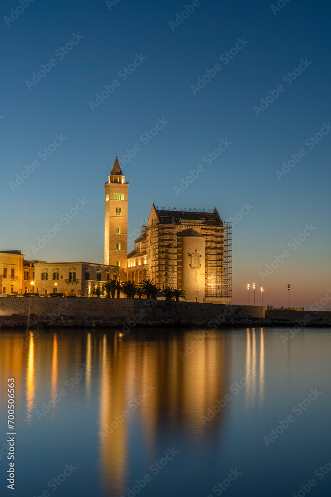 View of the beautiful Romanesque Cathedral Basilica of San Nicola Pellegrino from port on sunset, in Trani.