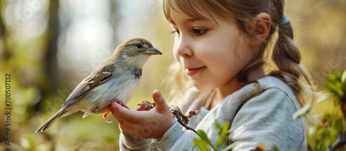 An ornithologist shows children how bird banding is important for environmental conservation. Creative Banner. Copyspace image photo