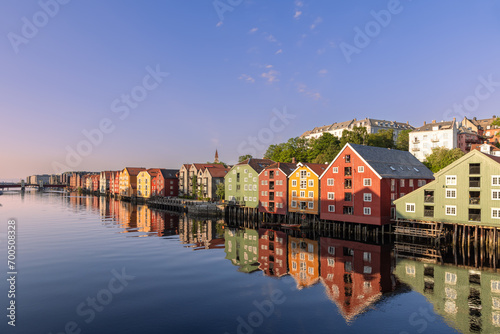 Evening glow over the Nidelva River with famous wooden houses along its shore during a summer sunset in Trondheim, Norway