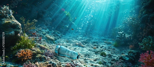 A very old non biodegradable plastic bottle on the sea floor on a tropical coral reef. Creative Banner. Copyspace image