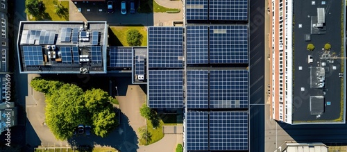 A top down shot directly over a large school building with many solar panels on the roof on a sunny day The drone camera is high up looking down. Creative Banner. Copyspace image