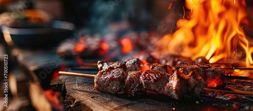 Large pieces of meat are baked and fried on spits Barbecue ham hock smoked meat grilled in an open fire flame in Oktoberfest. Creative Banner. Copyspace image photo