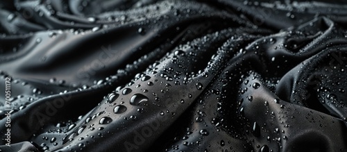Lotus effect with water drops on black textile. Creative Banner. Copyspace image photo
