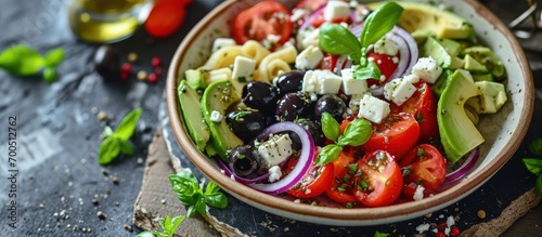 Greek Pasta Salad with tomato avocado black olives red onions and cheese feta banner menu recipe place for text top view. Creative Banner. Copyspace image photo