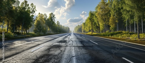 A wide open highway on a spring day with forest and vegetation on either side of it The highway is rough due to being repaved. Creative Banner. Copyspace image photo