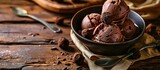 Homemade artisanal chocolate ice cream on a wooden table with spoon and chocolate truffles. Creative Banner. Copyspace image