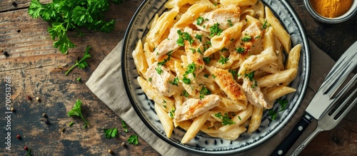 Homemade Chicken Alfredo Penne with Parsley on cloth top view Overhead from above flat lay. Creative Banner. Copyspace image