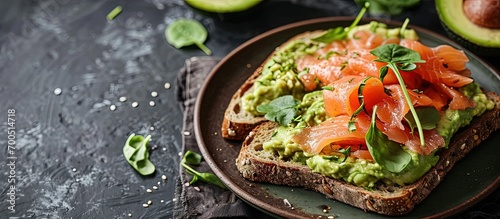 Healthy food avocado and red fish salmon toast sandwich for breakfast or keto dieting top view. Creative Banner. Copyspace image