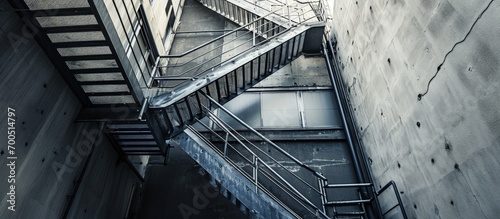 A high metal ladder that serves as a fire escape Emergency exit Galvanized metal staircase in the building. Creative Banner. Copyspace image photo