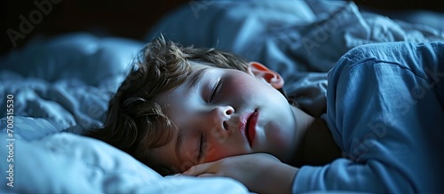 Little boy snoring while sleeping on bed at night. Creative Banner. Copyspace image photo