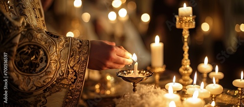 Christening ceremony in the Orthodox church priest lighting candles at children baptismal font close up. Creative Banner. Copyspace image photo