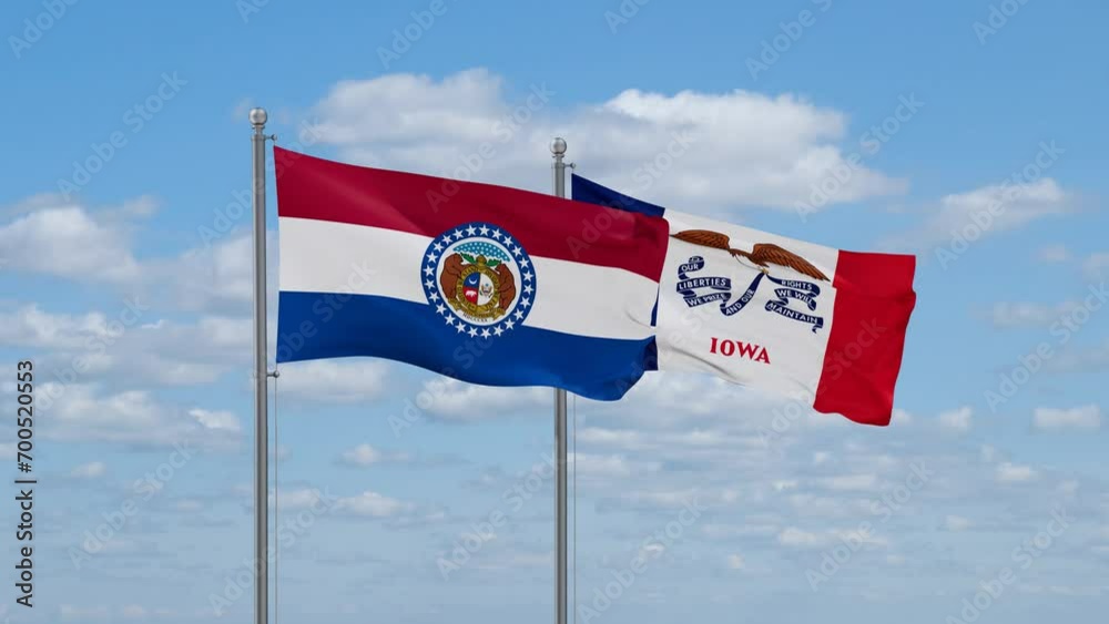 Iowa and Missouri US state flags waving together on cloudy sky, endless seamless loop Iowa and Missouri US state flags waving together on cloudy sky, endless seamless loop