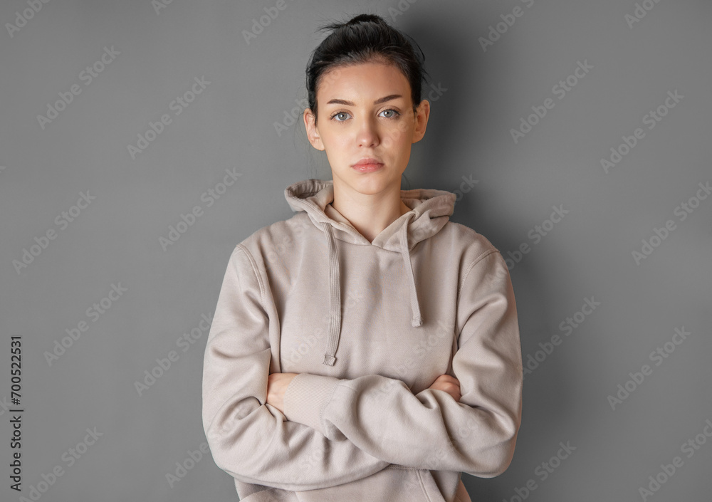 Fototapeta premium Pensive thoughtful young girl wearing sweatshirt with hood