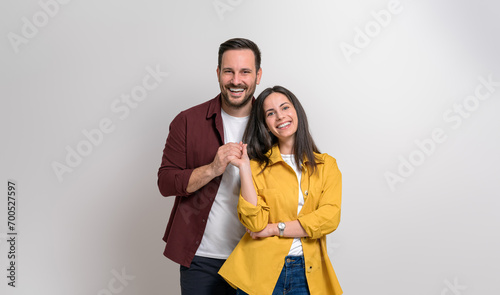 Slika na platnu Portrait of loving young boyfriend and girlfriend holding hands and posing over