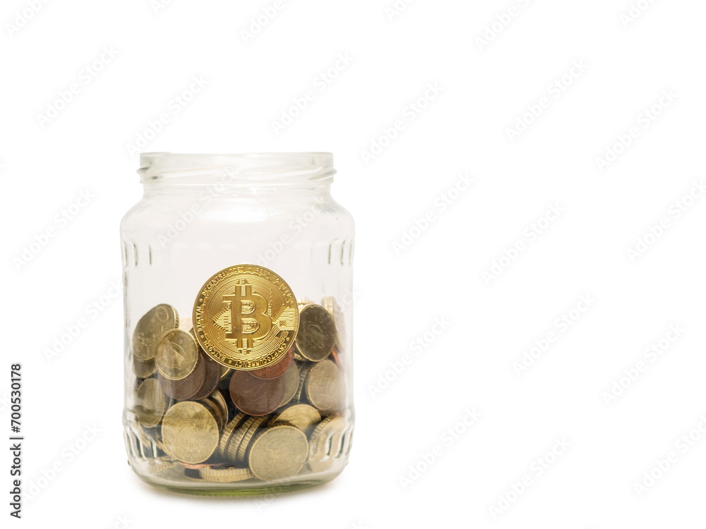 Golden bitcoin on a glass jar with coins on white background. Finance and digital currency concept. Investing in crypto money and creating wealth theme. Copy space, selective focus. Golden bitcoin on a glass jar with coins on white background. Finance and digital currency concept. Investing in crypto money and creating wealth theme. Copy space, selective focus.
