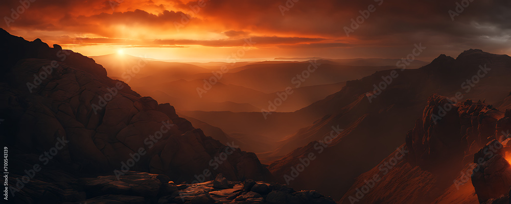 a mesmerizing sunset, with a fiery orange sun setting amidst a backdrop of dark, rocky terrain.