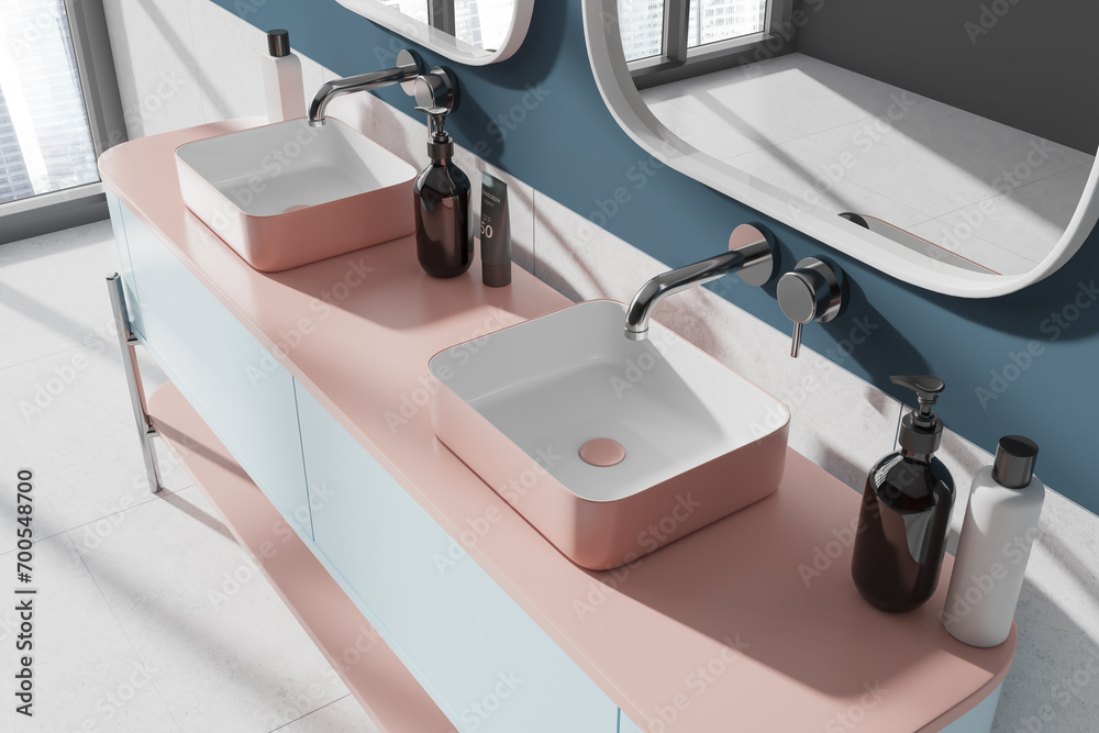 Top view of modern bathroom interior with double sink and mirrors, window