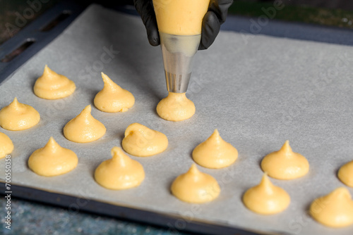 The process of making profiteroles using a cooking bag. Confectionery. Close up
