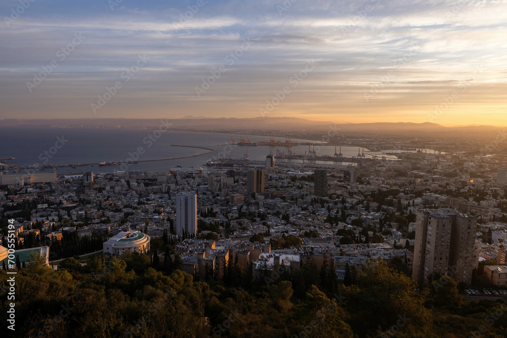 Beautiful panoramic view from Mount Carmel (Louis Promenade) beautiful dramatic marmalade sky  cityscape and port in Haifa, Israel.